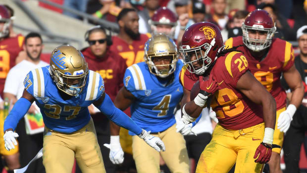 Nov 20, 2021; Los Angeles, California, USA; Southern California Trojans running back Keaontay Ingram (28) runs past UCLA Bruins defensive back Quentin Lake (37) in the first half at the Los Angeles Memorial Coliseum.
