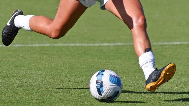 A close-up shot of Houston Dash defender Ally Prisock (23) kicking the ball.