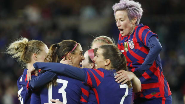 The United States Women's National Team celebrates a goal during a game.