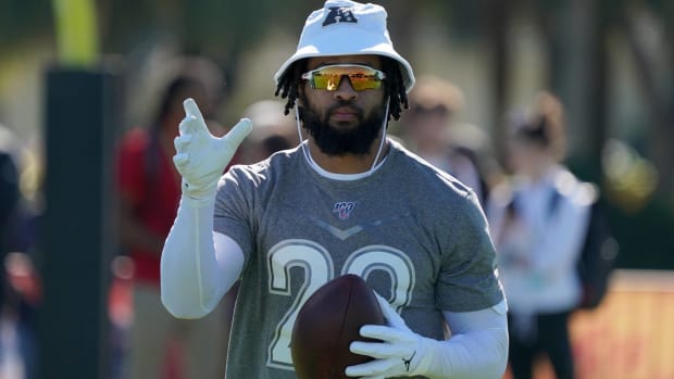 Ravens safety Earl Thomas holds a football during Pro Bowl practice.