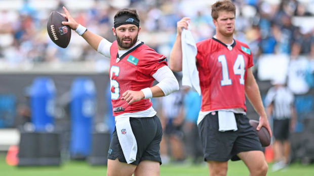 Panthers quarterbacks Baker Mayfield and Sam Darnold with their helmets off during practice.