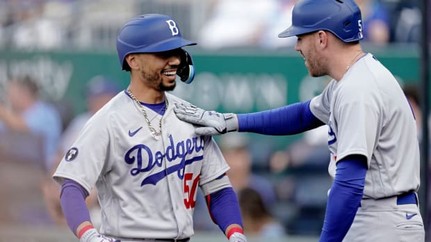 Los Angeles Dodgers’ Mookie Betts, left, celebrates with Freddie Freeman after hitting a solo home run during the first inning of a baseball game against the Kansas City Royals Saturday, Aug. 13, 2022, in Kansas City, Mo. (AP Photo/Charlie Riedel)