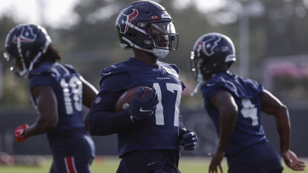 Texans wide receiver Jalen Camp runs with a ball during practice.