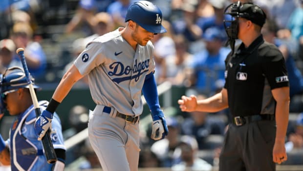Los Angeles Dodgers’ Trea Turner walks back to the dugout after striking out against the Kansas City Royals during the first inning of a baseball game, Sunday, Aug. 14, 2022, in Kansas City, Mo. (AP Photo/Reed Hoffmann)