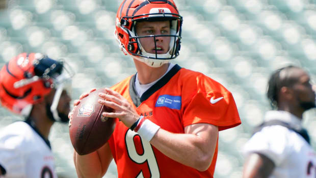 FILE - Cincinnati Bengals quarterback Joe Burrow (9) takes part in drills at the team’s NFL football stadium, Tuesday, June 14, 2022, in Cincinnati. Bengals owner Mike Brown said the team already has an eye on structuring finances so they can pay Joe Burrow enough to stay in Cincinnati when the star quarterback becomes eligible to negotiate a new contract next year. (AP Photo/Jeff Dean, File)