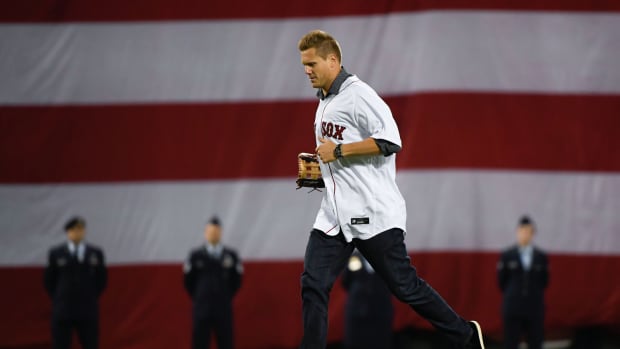 Oct 18, 2021; Boston, Massachusetts, USA; Former Boston Red Sox pitcher Jonathan Papelbon runs onto the field for the ceremonial first pitch before game three of the 2021 ALCS against the Houston Astros at Fenway Park.