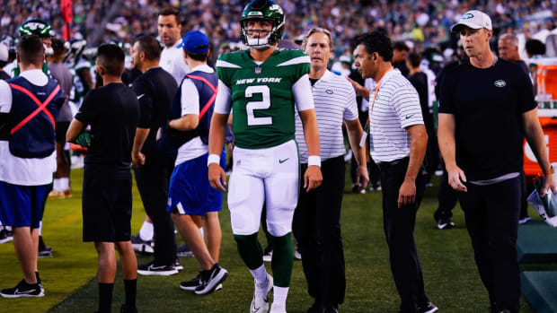 New York Jets’ Zach Wilson walks on the sidelines after he is taken off the field following an injury during the first half of a preseason NFL football game against the Philadelphia Eagles on Friday, Aug. 12, 2022, in Philadelphia. (AP Photo/Matt Rourke)