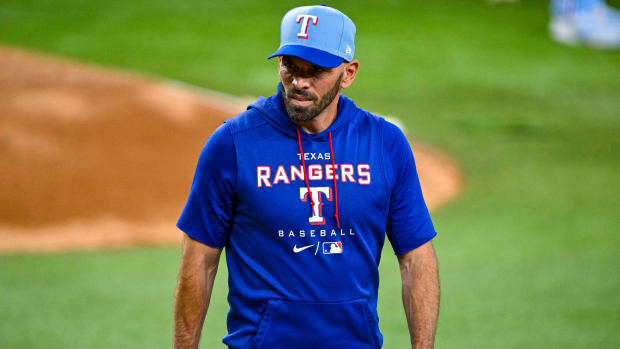 Rangers manager Chris Woodward (8) looks on during a game against the White Sox.
