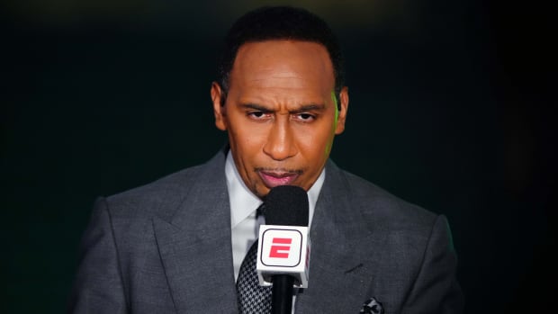 ESPN reporter Stephen A. Smith holds a microphone prior to an NBA Finals game between the Suns and the Bucks.