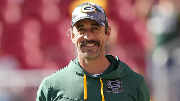 Packers quarterback Aaron Rodgers (12) smiles before a preseason game against the 49ers at Levi's Stadium.