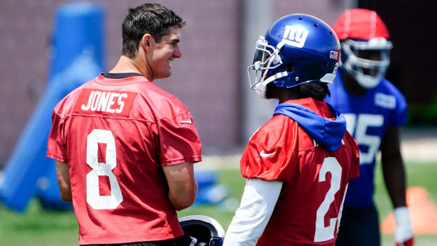 Giants quarterbacks Daniel Jones (8) and Tyrod Taylor (2) talk during mandatory minicamp practice.